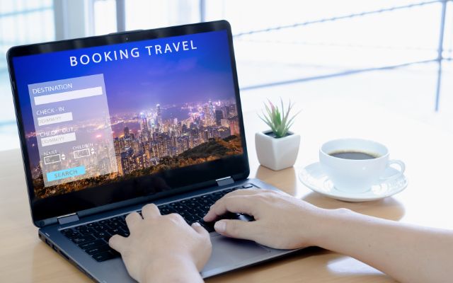 A person planning their vacation through a travel booking website with an online reservation system